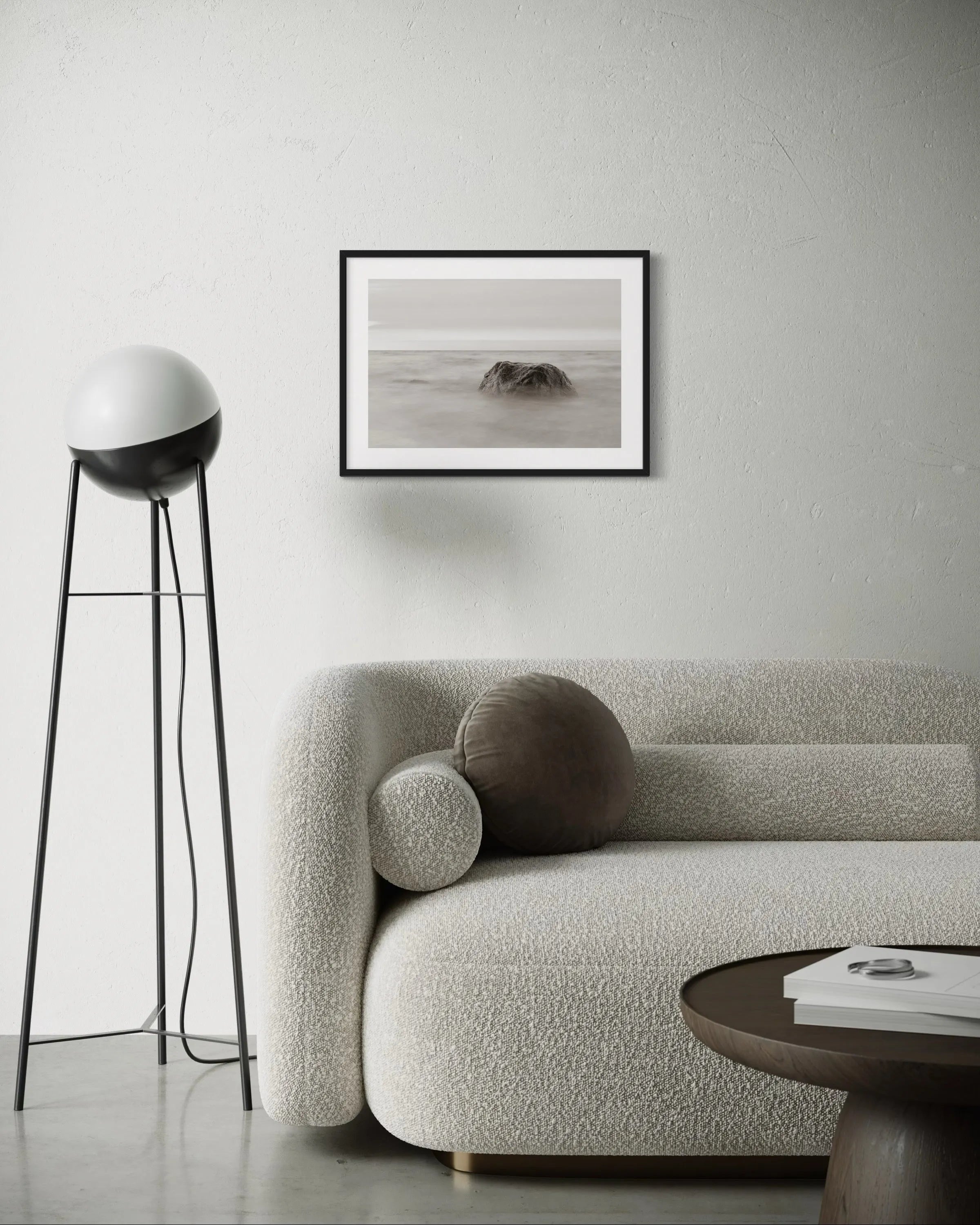 Framed fine art print Baltic Sea by Ziggy Kańczukowski displayed on a white wall in a modern living room with a textured sofa and floor lamp.