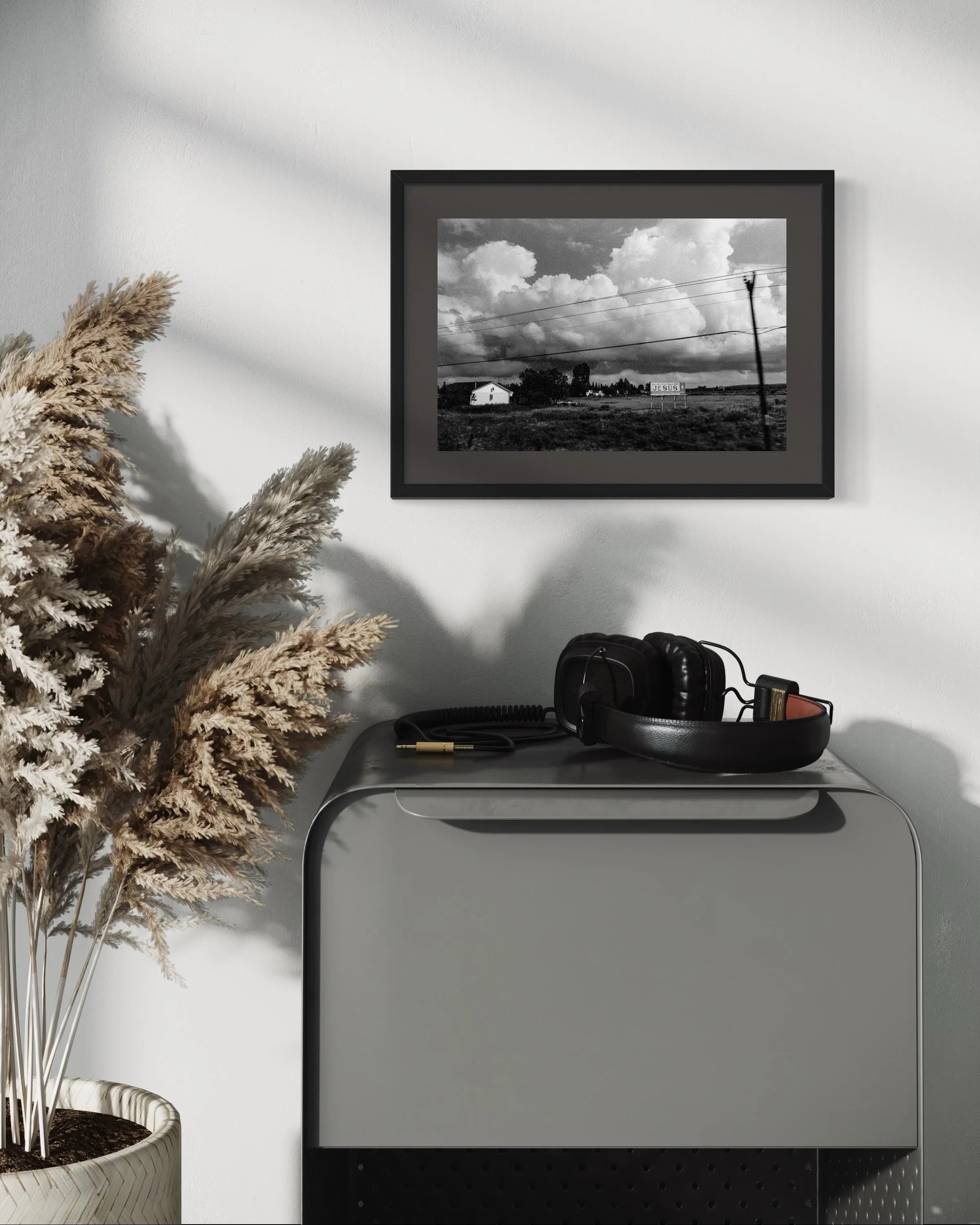 Framed black and white fine art landscape print Canada by Ziggy Kańczukowski displayed on a wall above a console table with decorative items.