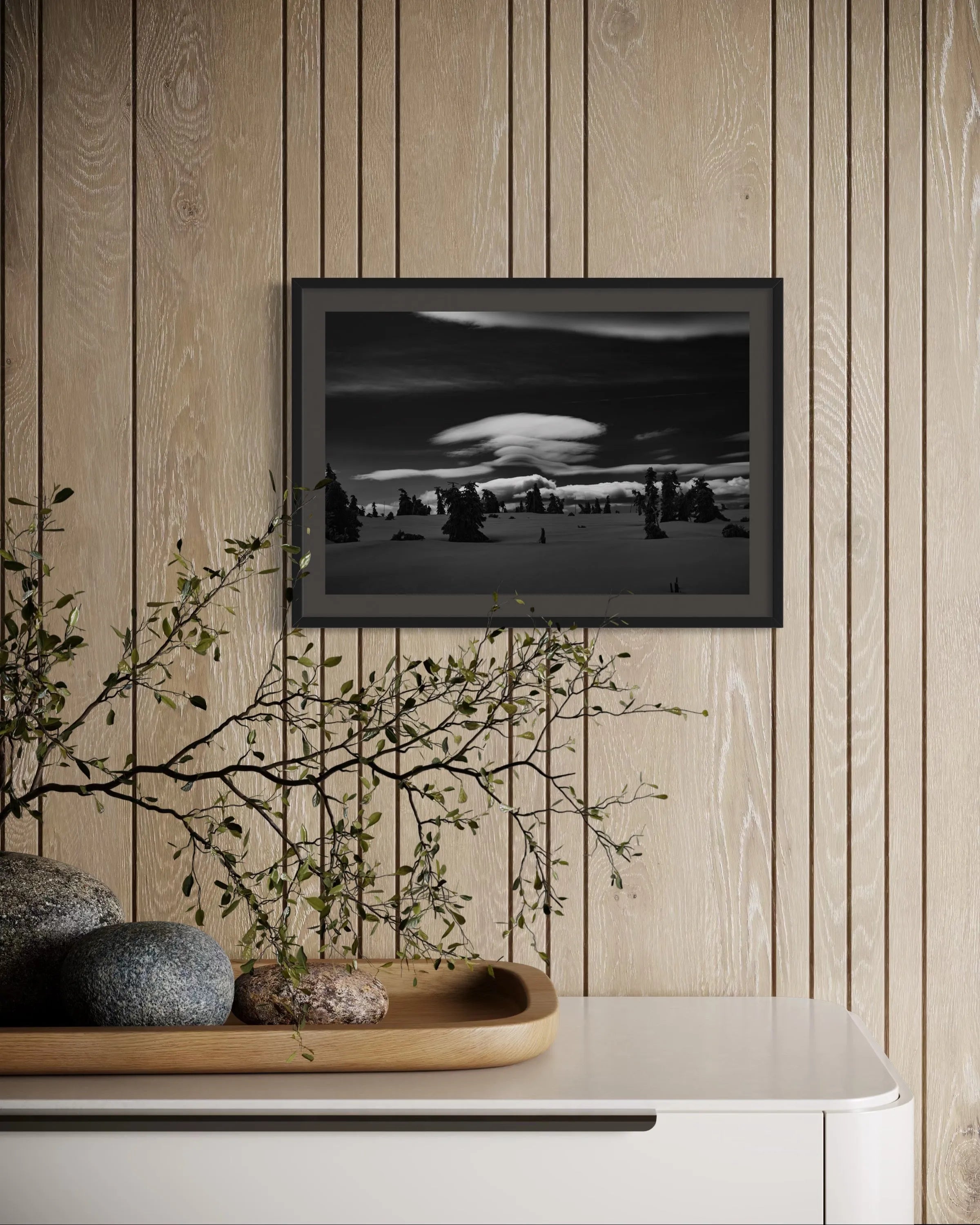 Framed black and white fine art print Karkonosze Mountains by Ziggy Kańczukowski displayed on a wooden wall with decorative elements below.