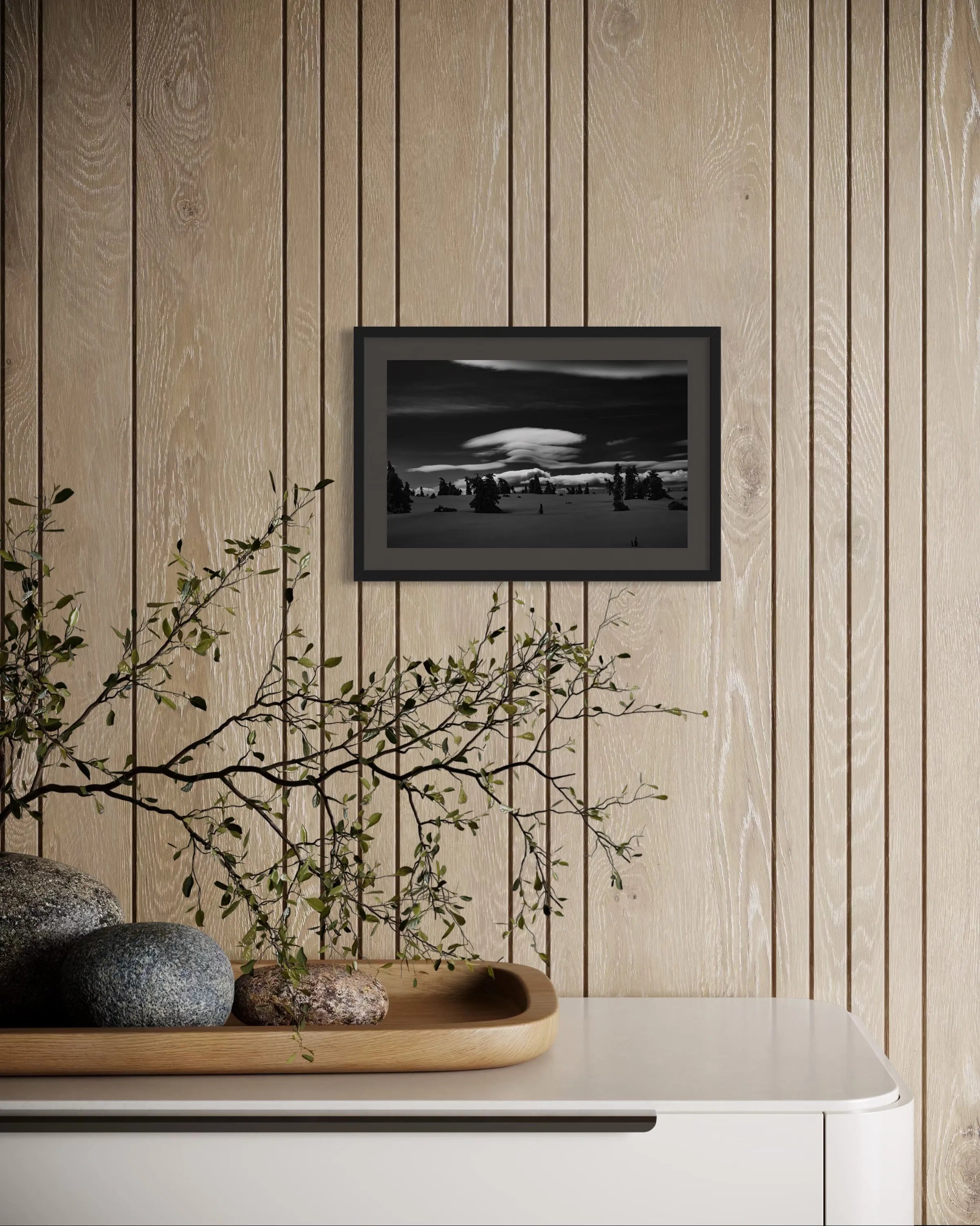 Framed black and white fine art print Karkonosze Mountains by Ziggy Kańczukowski displayed on a wooden wall with decorative elements below.