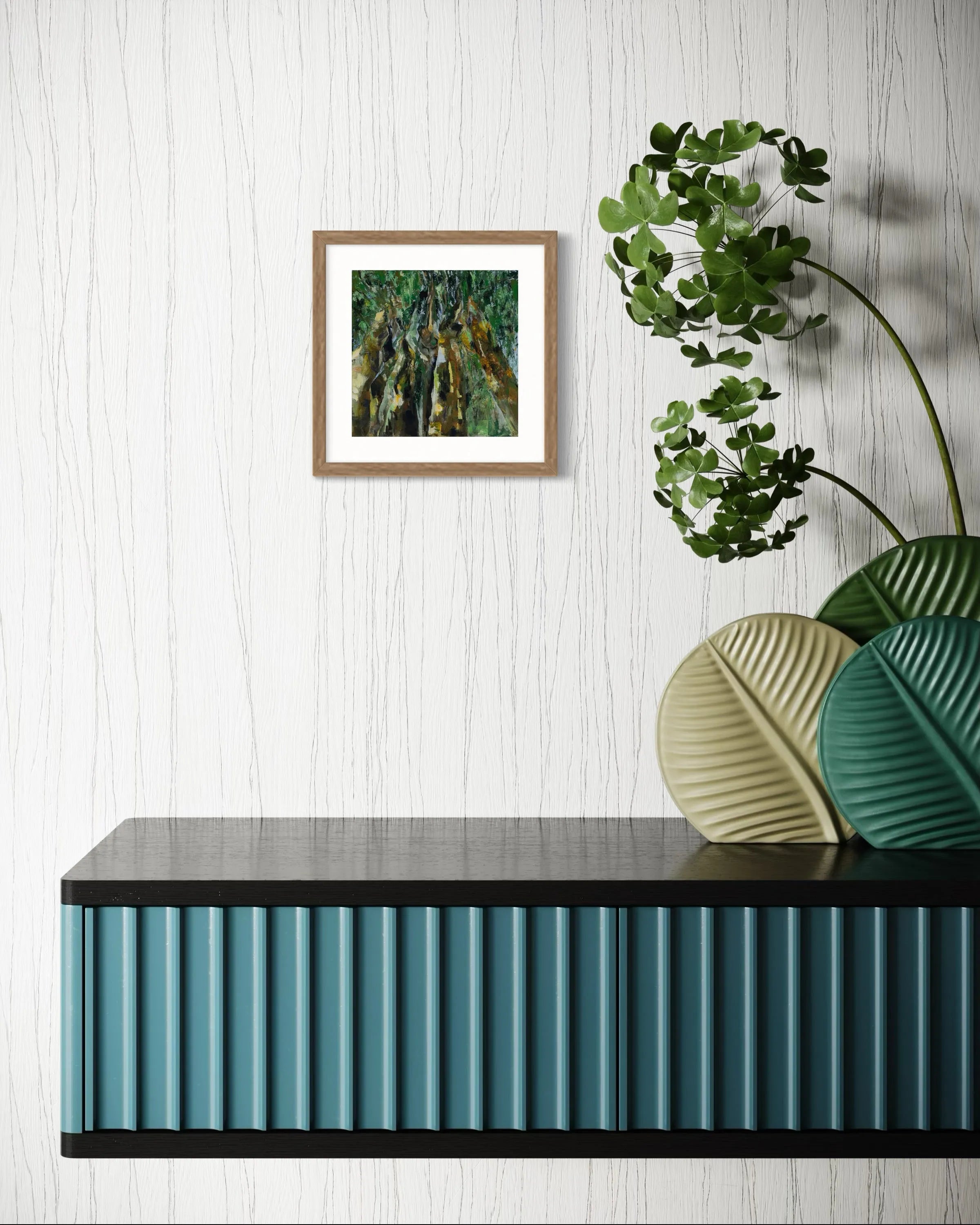 Framed abstract painting Nature II by Oliwia Tomczak displayed on a console table with a plant on a light wooden floor.