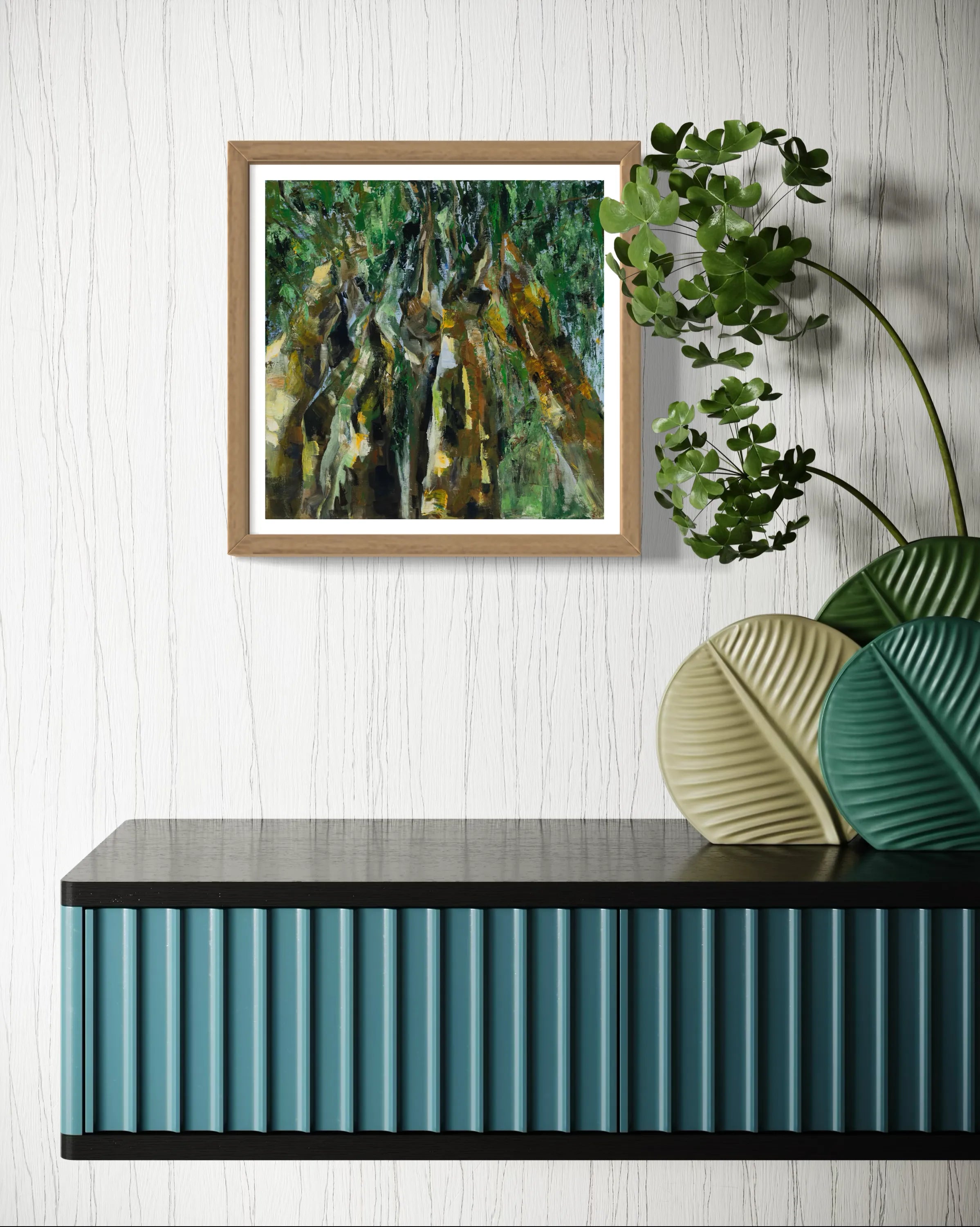 Framed abstract painting Nature II by Oliwia Tomczak displayed on a wall above a console table with decorative plants.