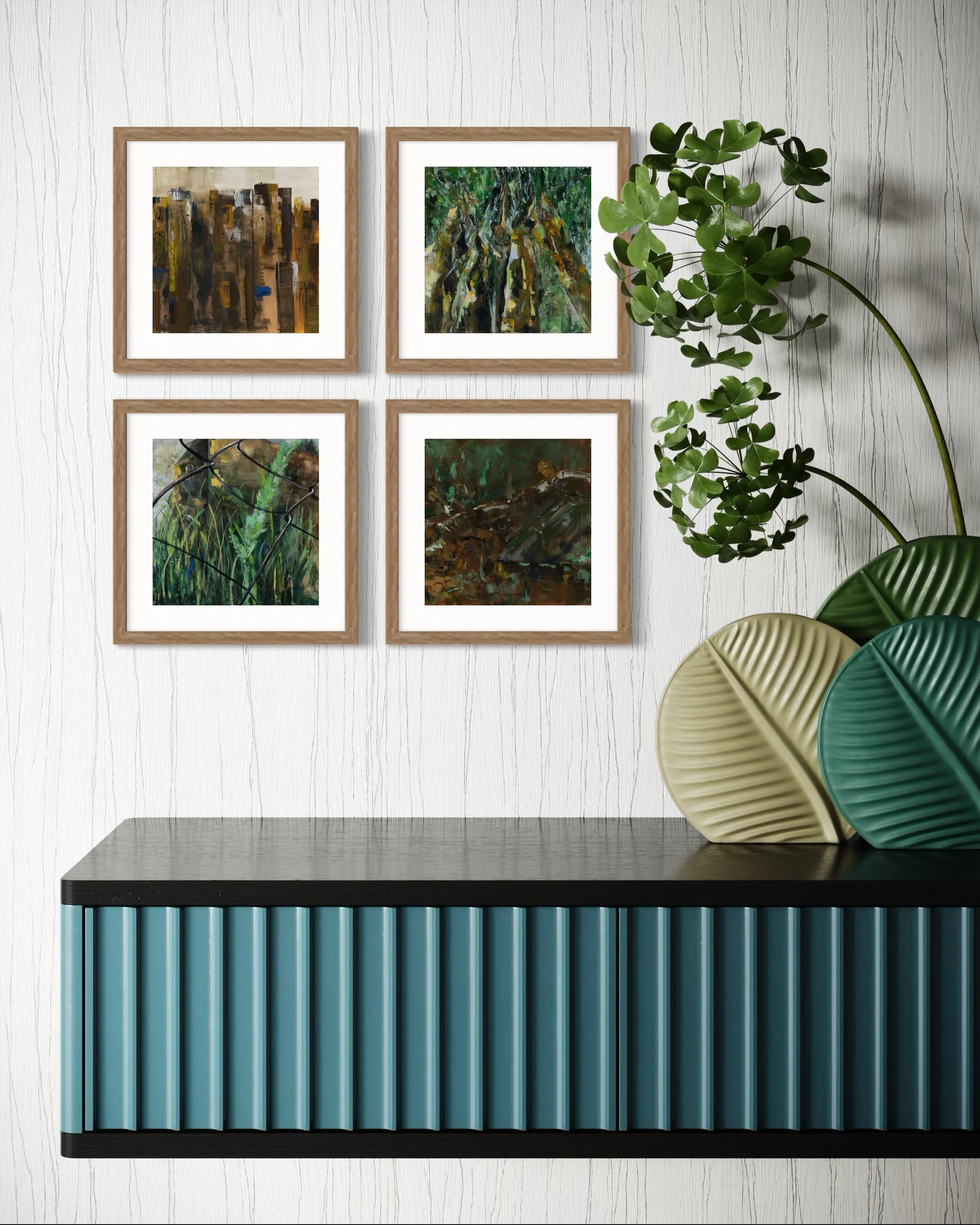 Four framed abstract paintings from the Nature collection by Oliwia Tomczak displayed on a wall above a decorative console table with plants.