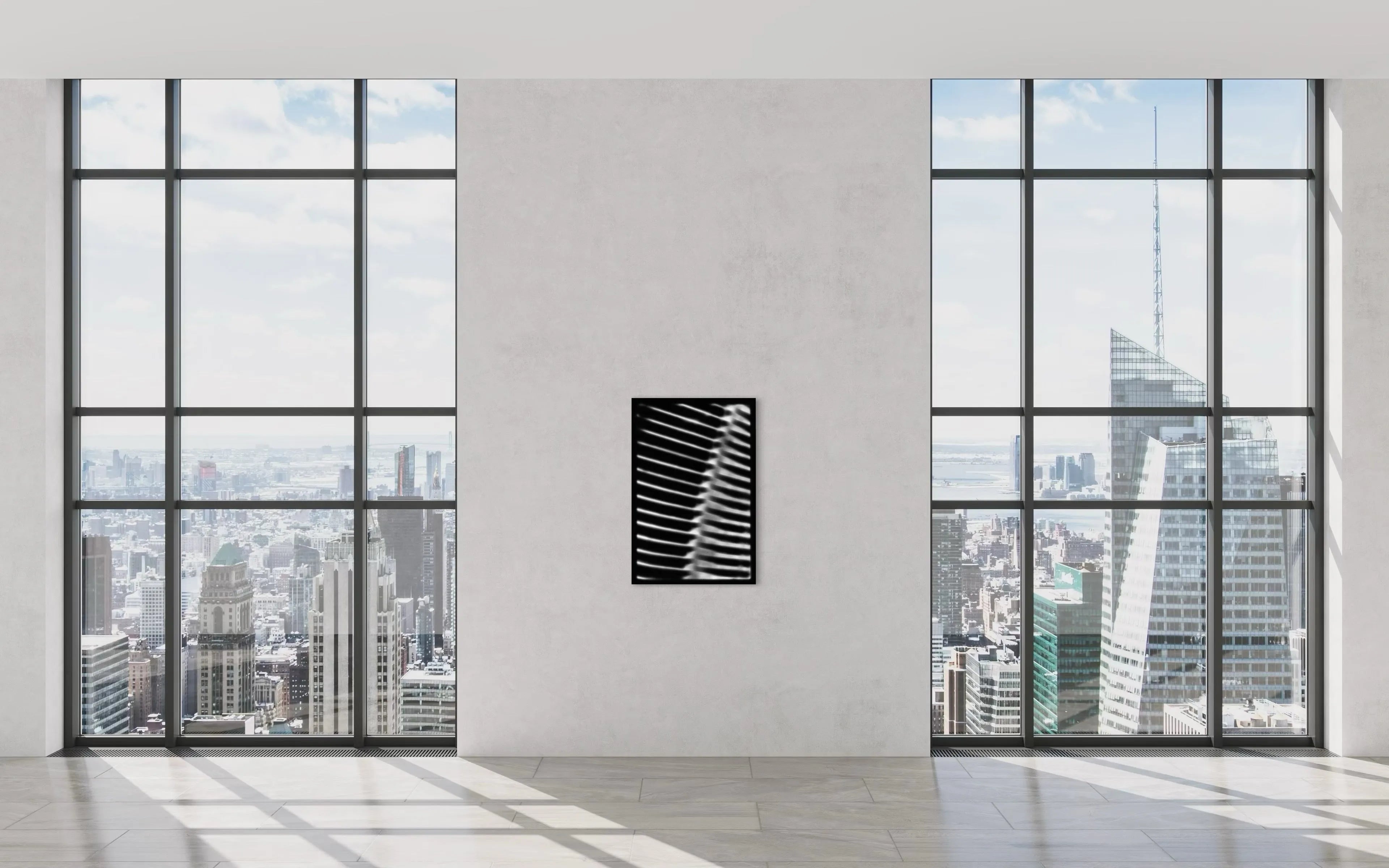 Framed minimalistic black and white abstract fine art print by Ziggy Kańczukowski displayed on a wall in a modern room with large windows offering a cityscape view.