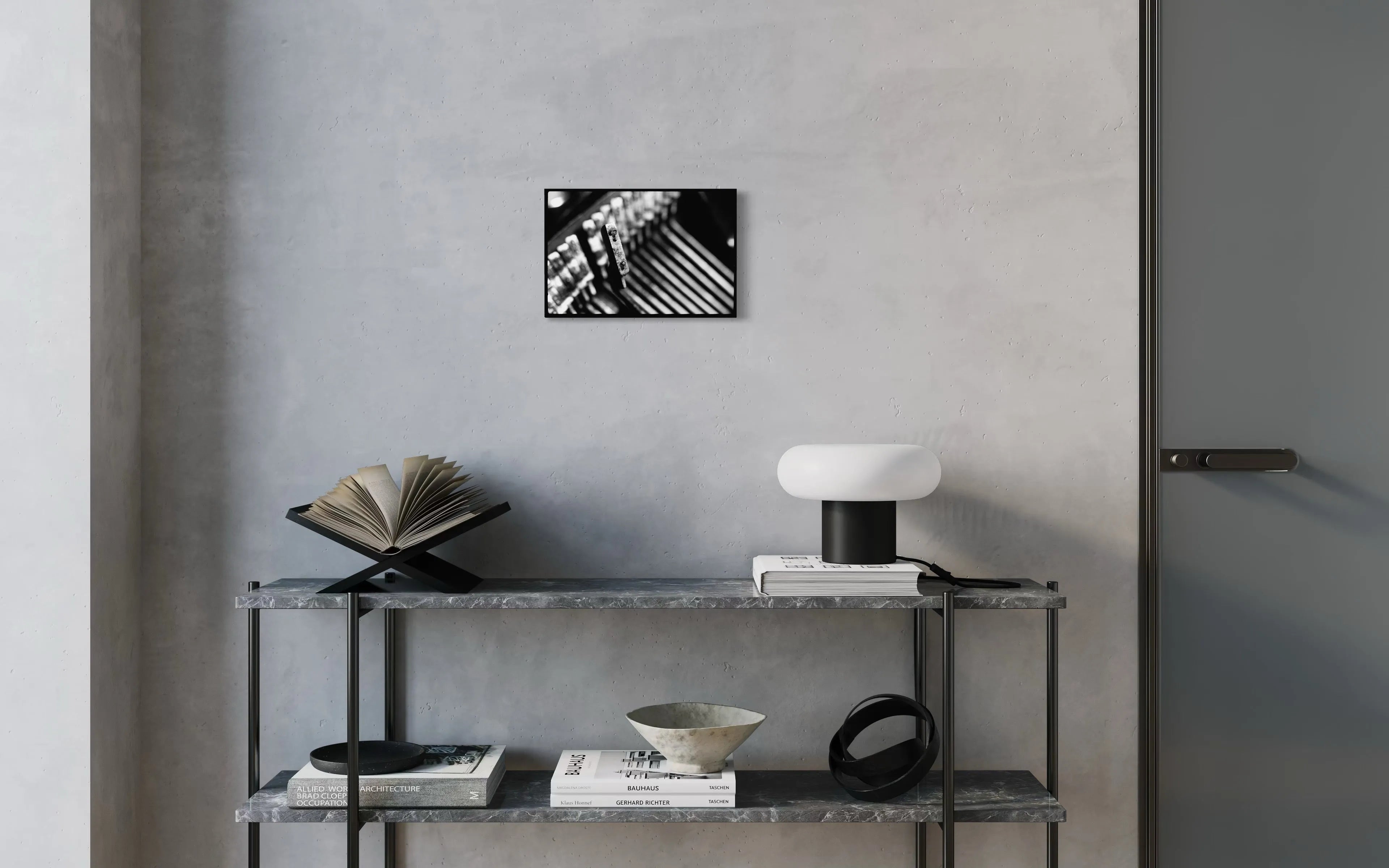 Framed black and white fine art print Machine 03 by Ziggy Kańczukowski displayed on a shelf against a gray wall in a modern interior.