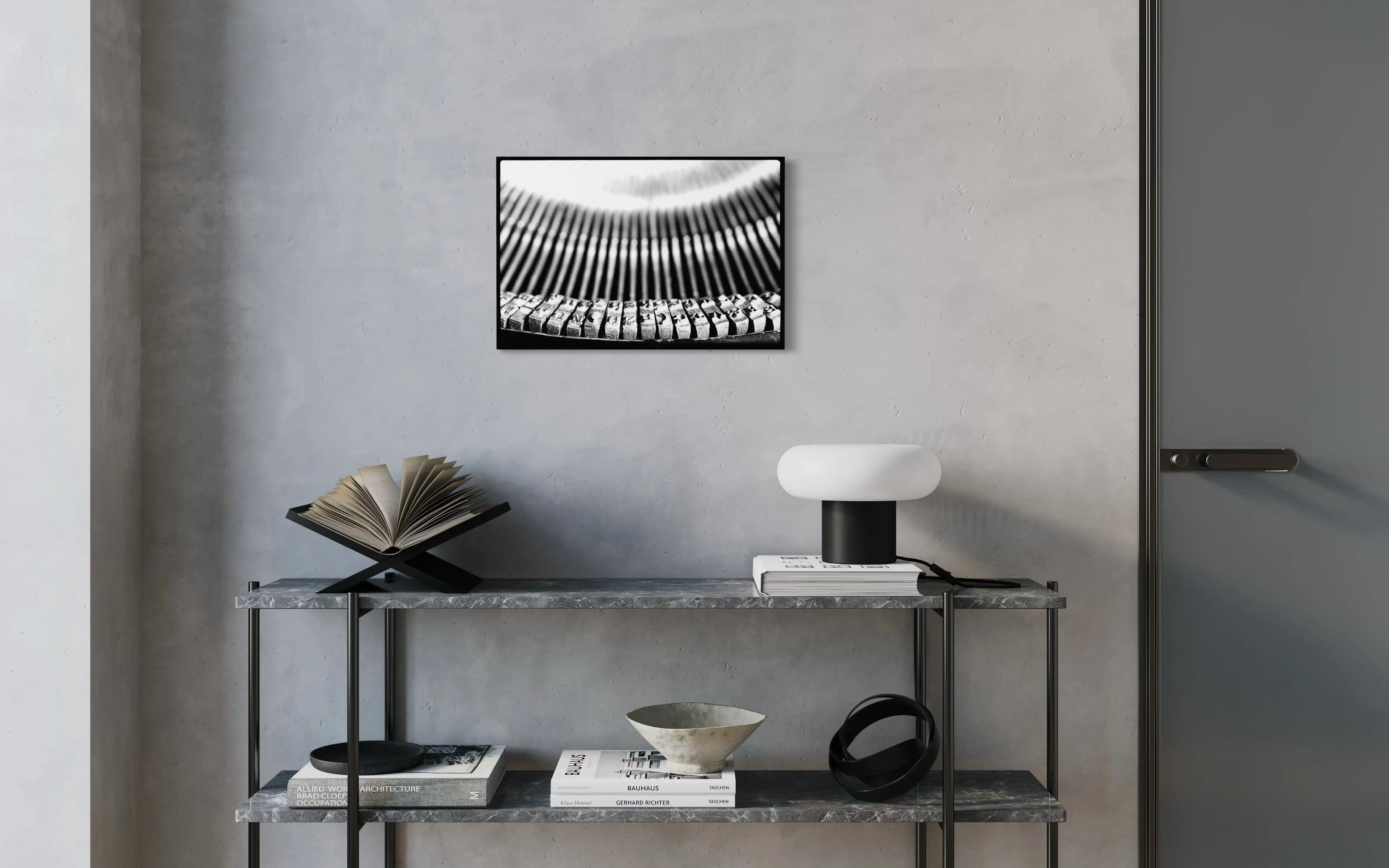 Framed black and white fine art print Machine 05 by Ziggy Kańczukowski displayed on a shelf against a gray wall in a modern interior.