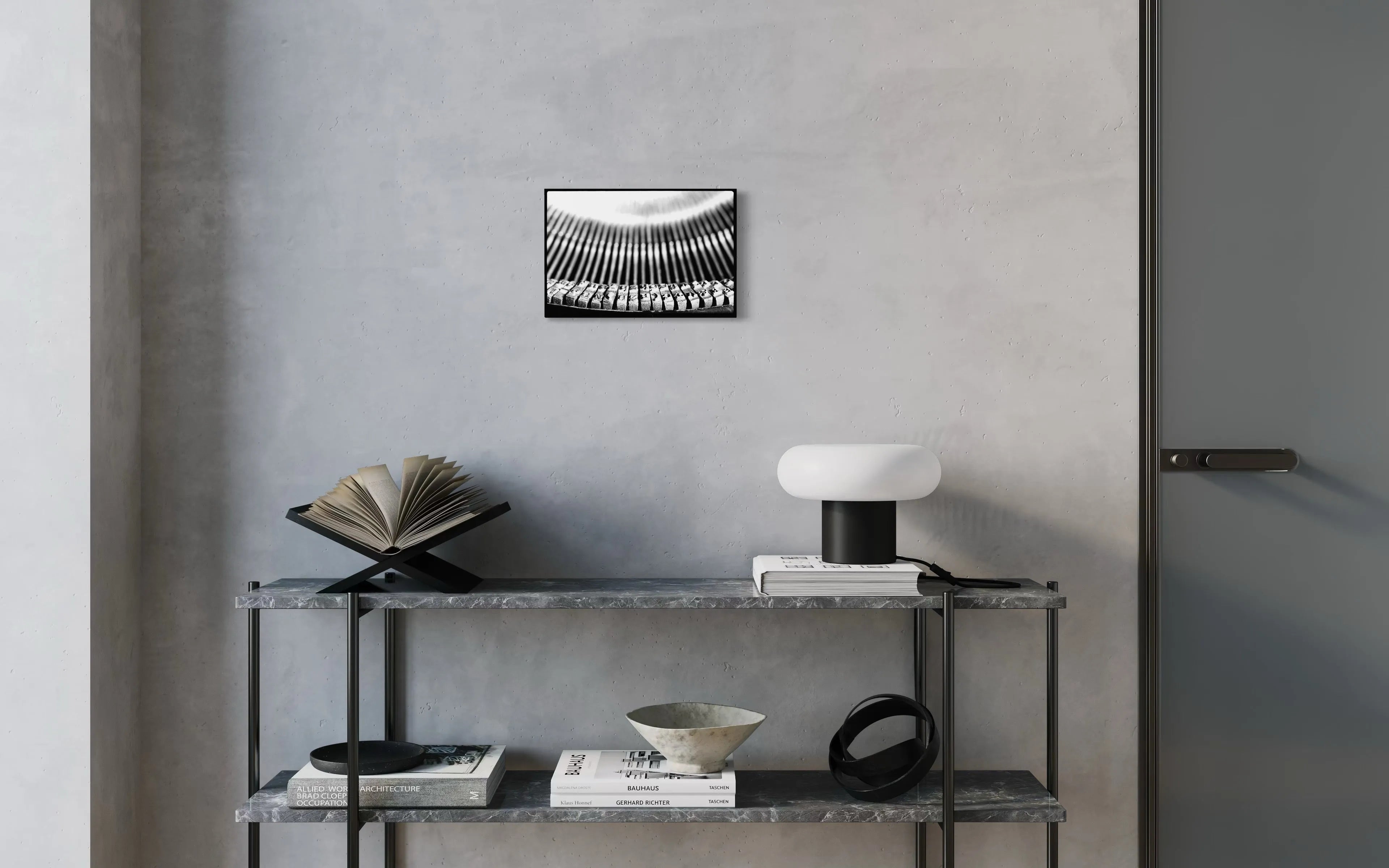 Framed black and white fine art print Machine 05 by Ziggy Kańczukowski displayed on a shelf against a gray wall in a modern interior.