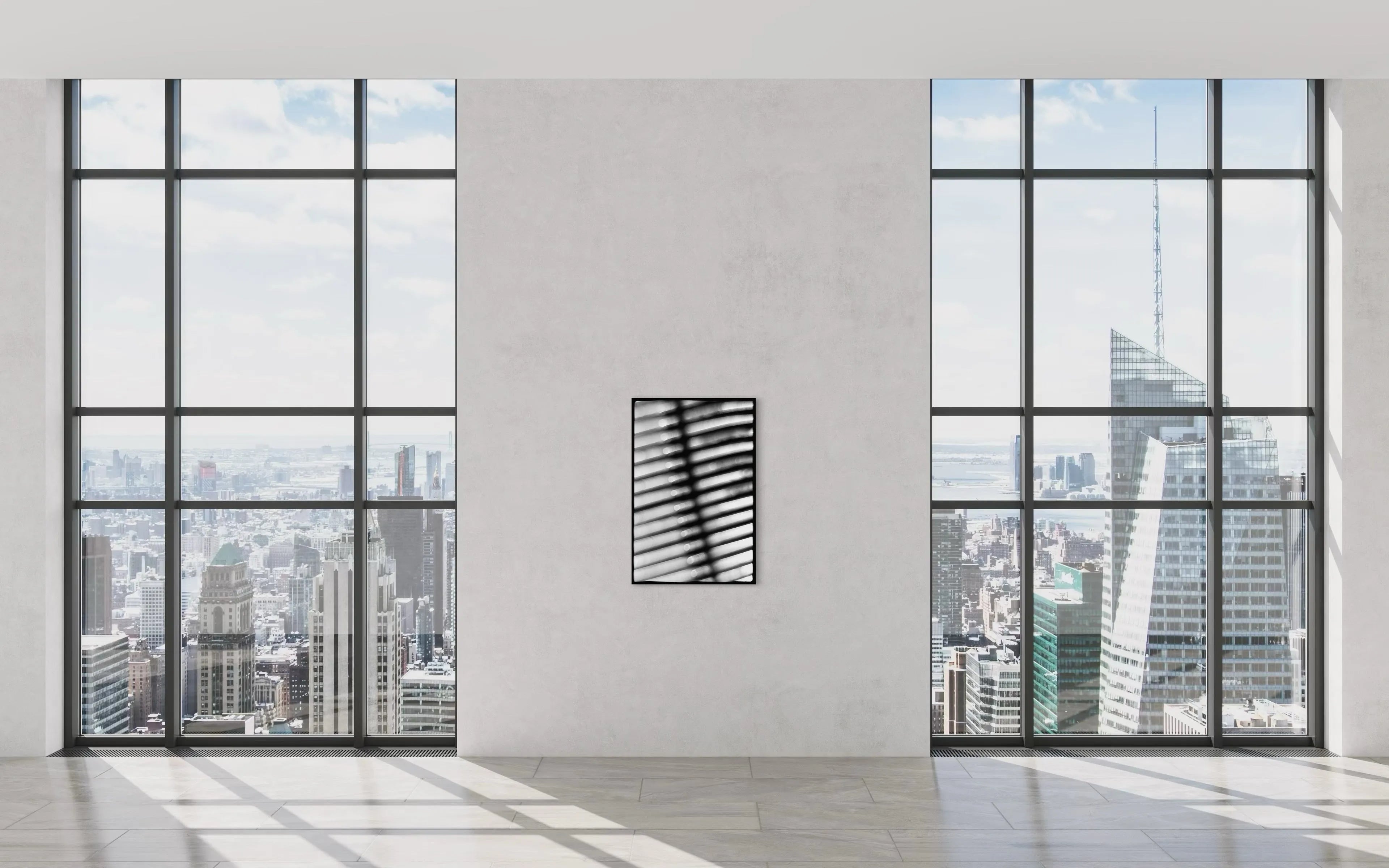 Framed minimalistic black and white fine art print Machine 06 by Ziggy Kańczukowski displayed on a wall in a modern room with large windows offering a cityscape view.