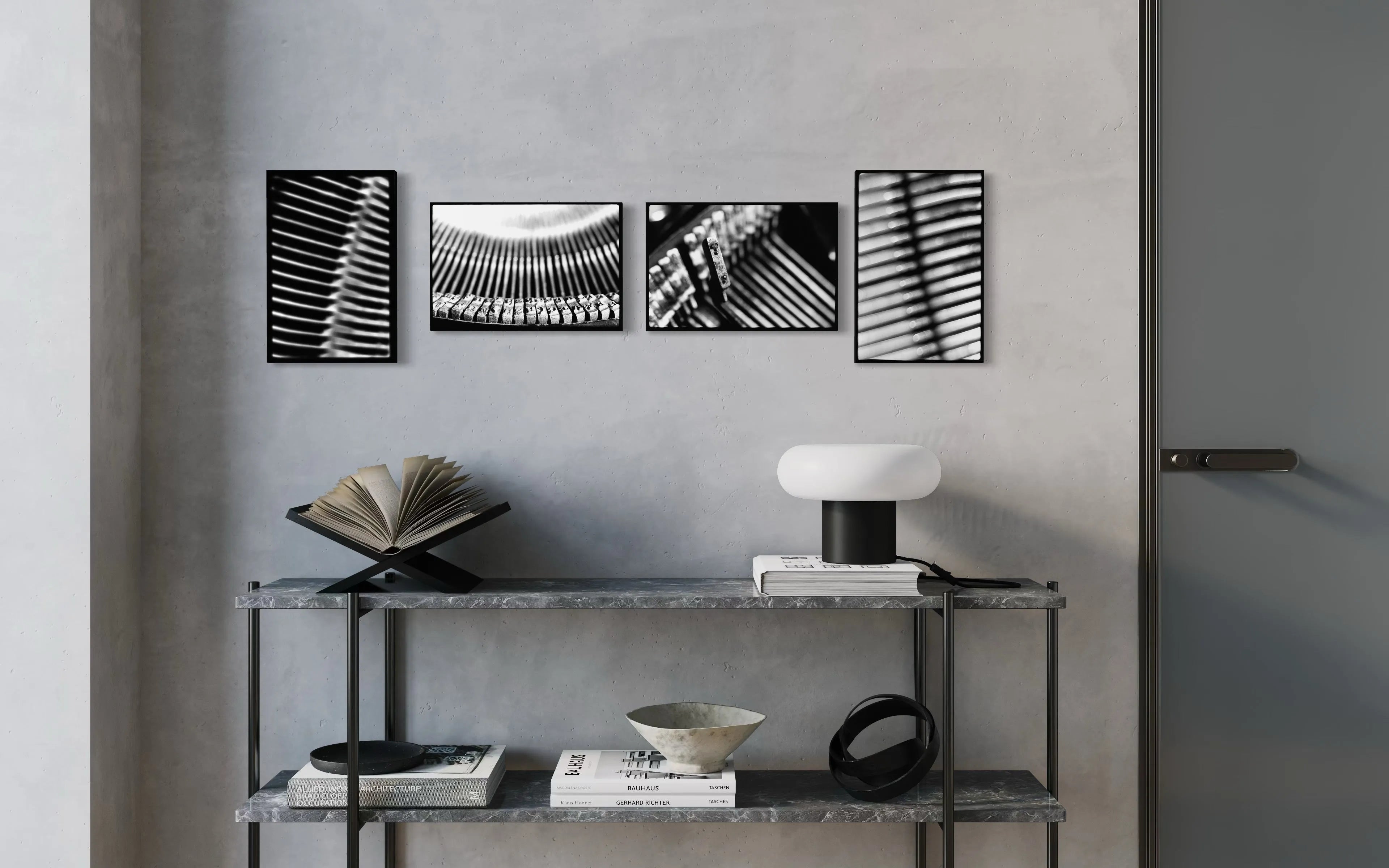 Framed black and white fine art print from the Machine collection by Ziggy Kańczukowski displayed above a console table with decorative items against a gray wall in a modern interior.
