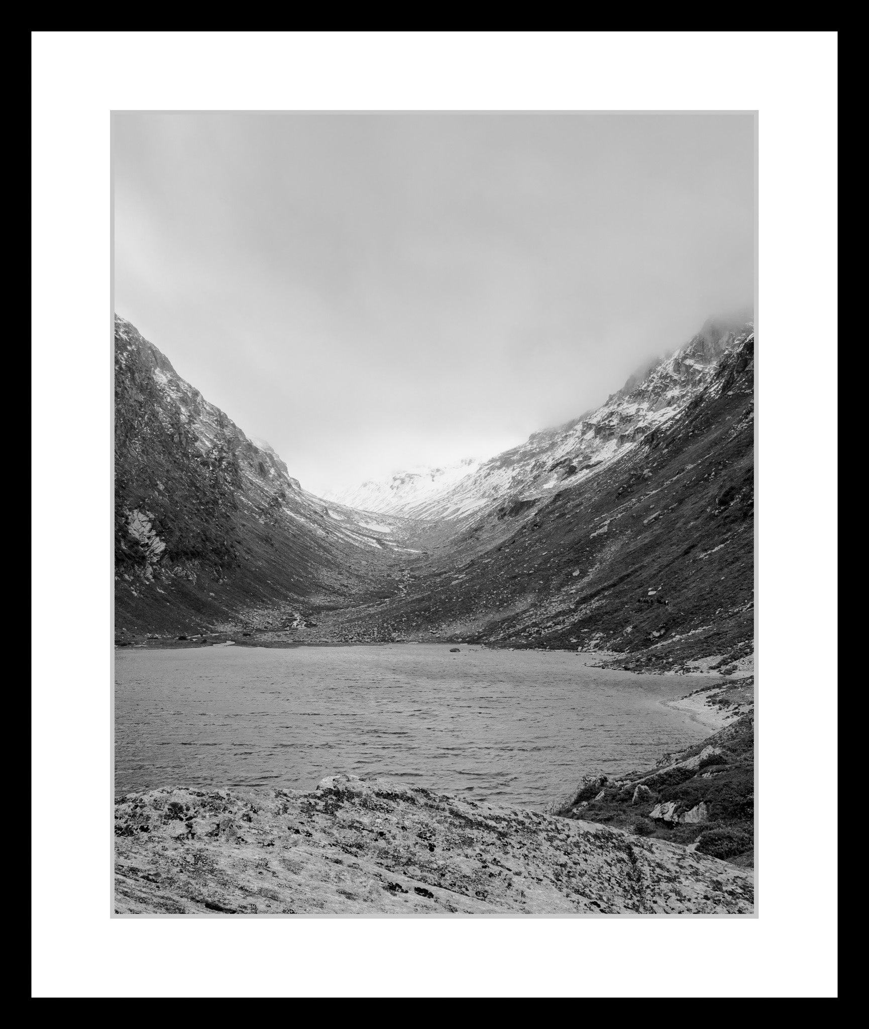 Black and white photograph of an alpine valley with a mountain lake in the High Tauern range, from the series High Tauern. The Zone Studies I by Ziggy Kanczukowski