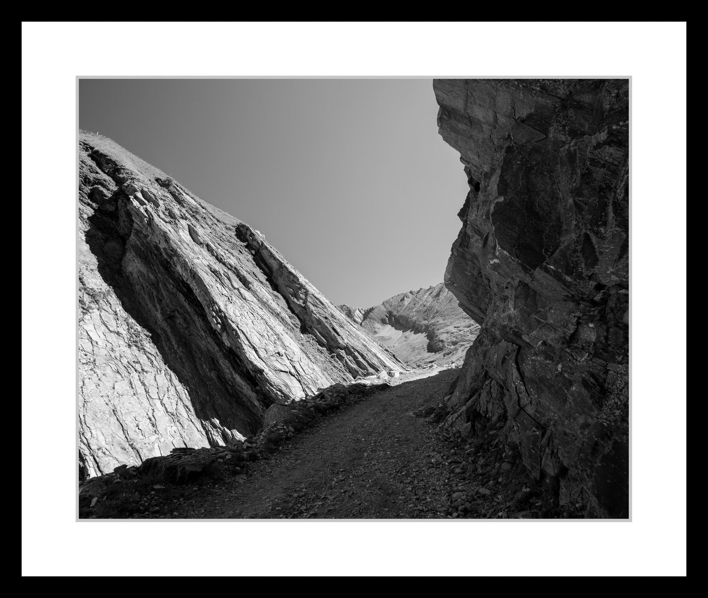 Black and white photograph of alpine slopes and rock formations in the High Tauern mountains, exploring rhythm and tonal balance, from the series High Tauern. The Zone Studies V by Ziggy Kanczukowski